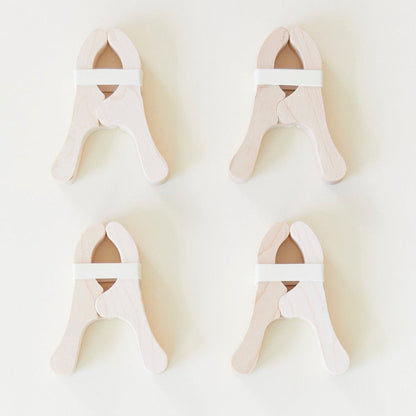 Four Playclips with white bands, arranged in a grid on a light background—perfect open-ended toys for creative play and fort building.